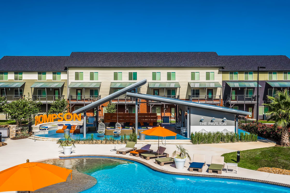 Aerial view of the resort-style swimming pool and outdoor lounge area at The Thompson in San Marcos, Texas