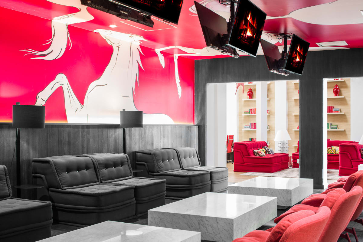 Resident lounge with multiple TV screens at The Scarlet in Lubbock, Texas