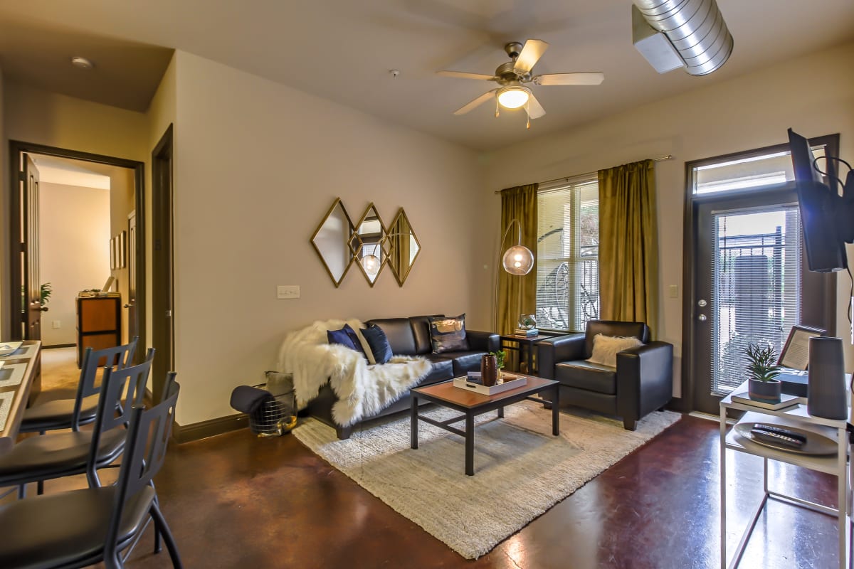Spacious living room opening onto a private patio at Crimson in Tuscaloosa, Alabama