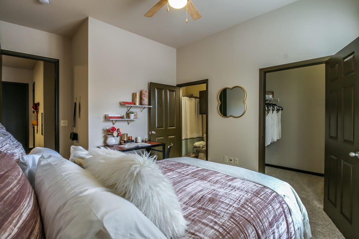 Bedroom with a large closet and private bathroom in a model student apartment at Crimson in Tuscaloosa, Alabama