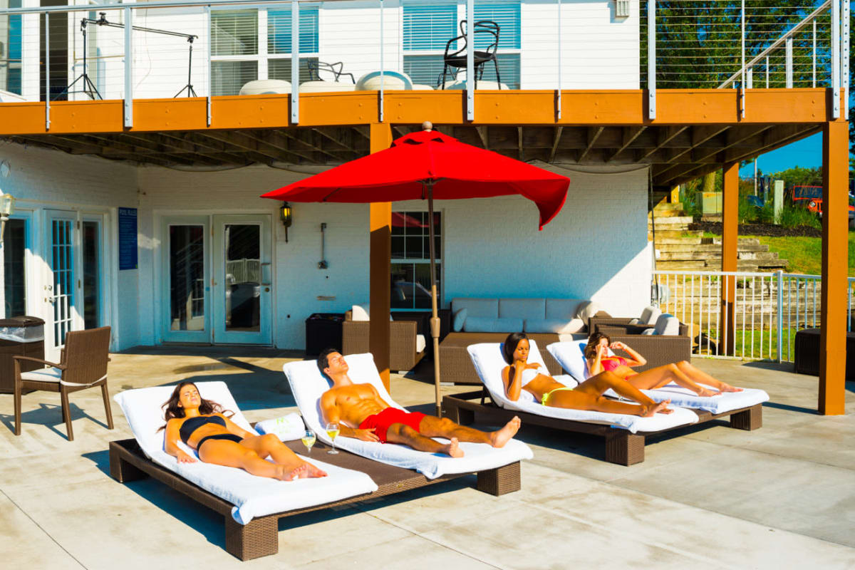 Sunny lounge chairs by the pool at Woodland Mews in Ann Arbor, Michigan