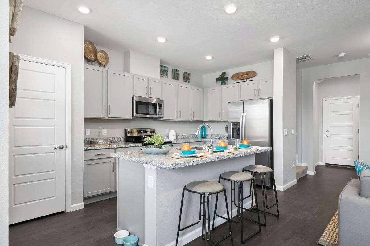 Large kitchen island with bar seats for guests to sit in at BB Living Murphy Creek in Aurora, Colorado