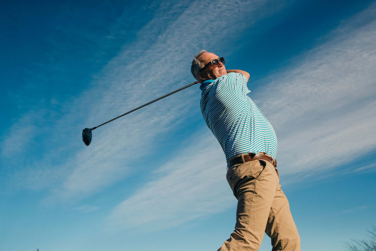 Resident playing golf on a nice clear day near BB Living Murphy Creek in Aurora, Colorado