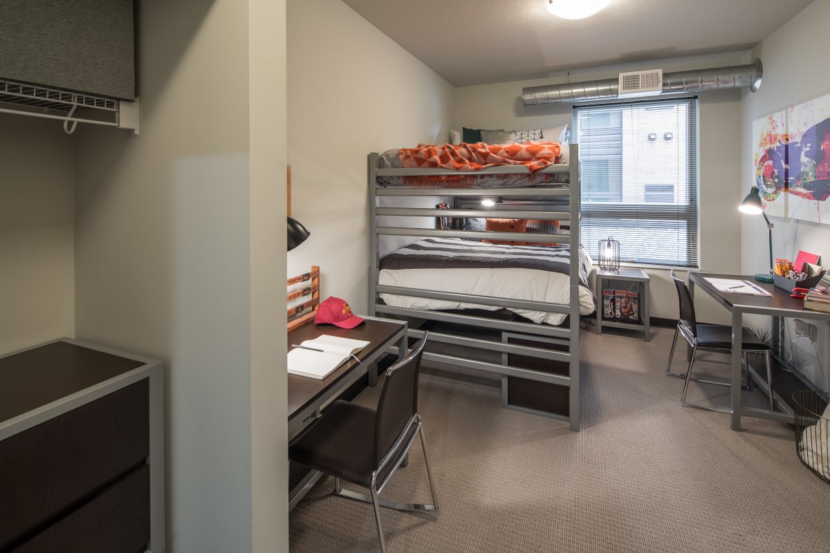 Bedroom with bunk beds and plenty of closet space in a student apartment at The Foundry in Ames, Iowa