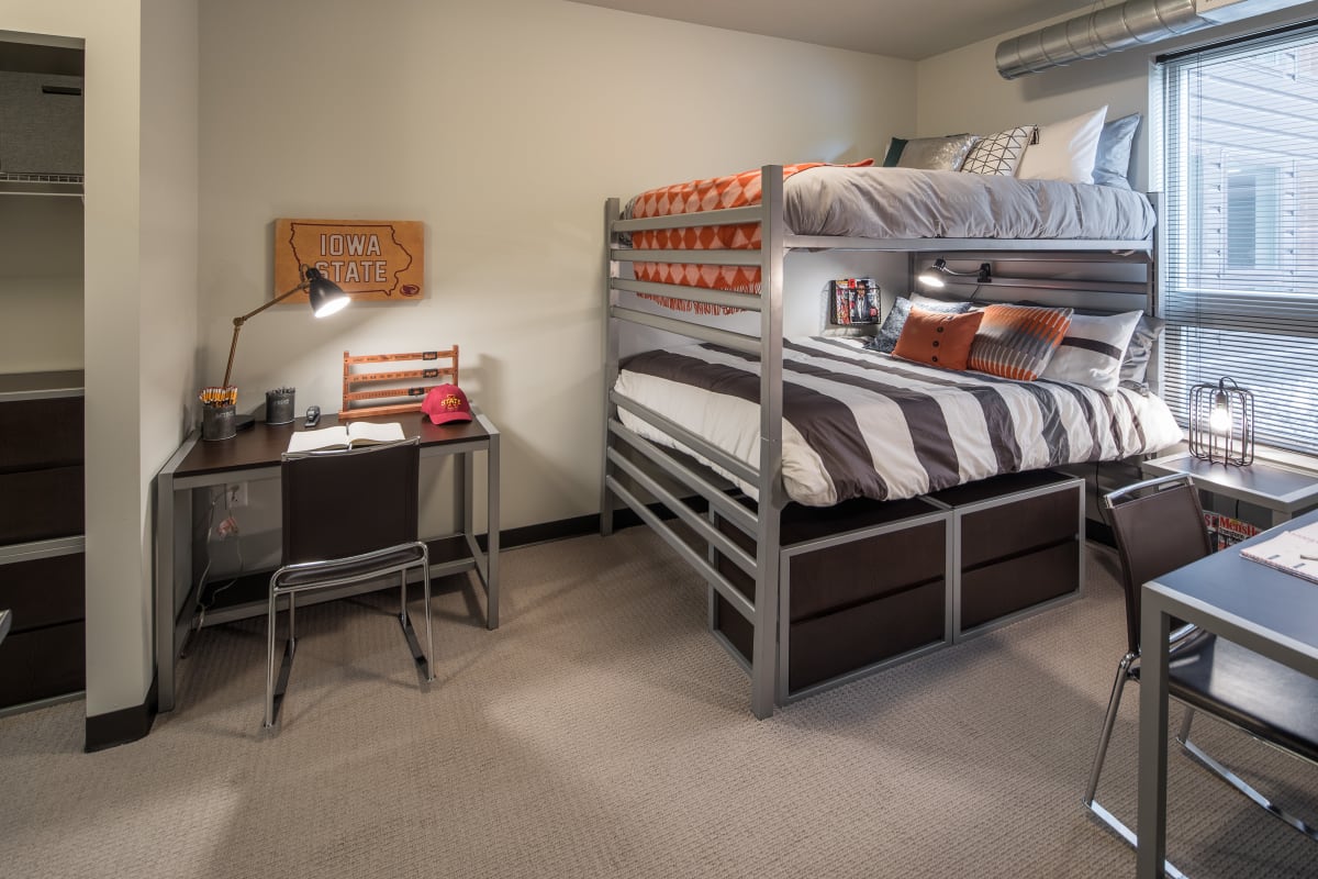 Model student bedroom with bunk beds and two desks at The Foundry in Ames, Iowa