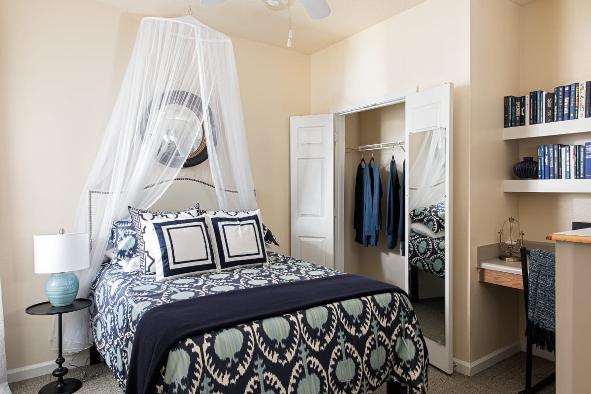 Bedroom with a large closet and built-in desk at River Pointe in Carrollton, Georgia