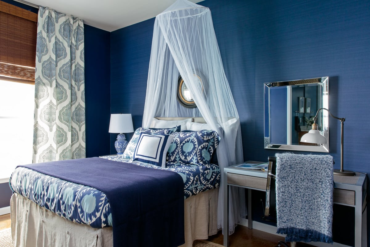 Model bedroom with a blue accent wall at The Vic in Greensboro, North Carolina
