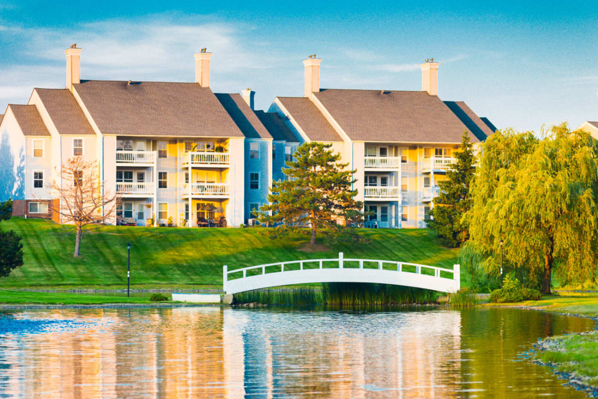 Exterior and walking bridge across pond at Woodland Mews in Ann Arbor, Michigan