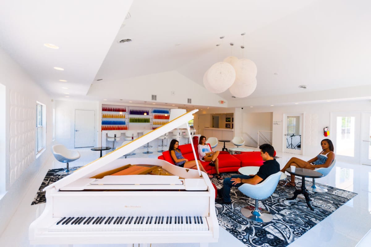 Boutique resident clubhouse with a baby grand piano at Woodland Mews in Ann Arbor, Michigan