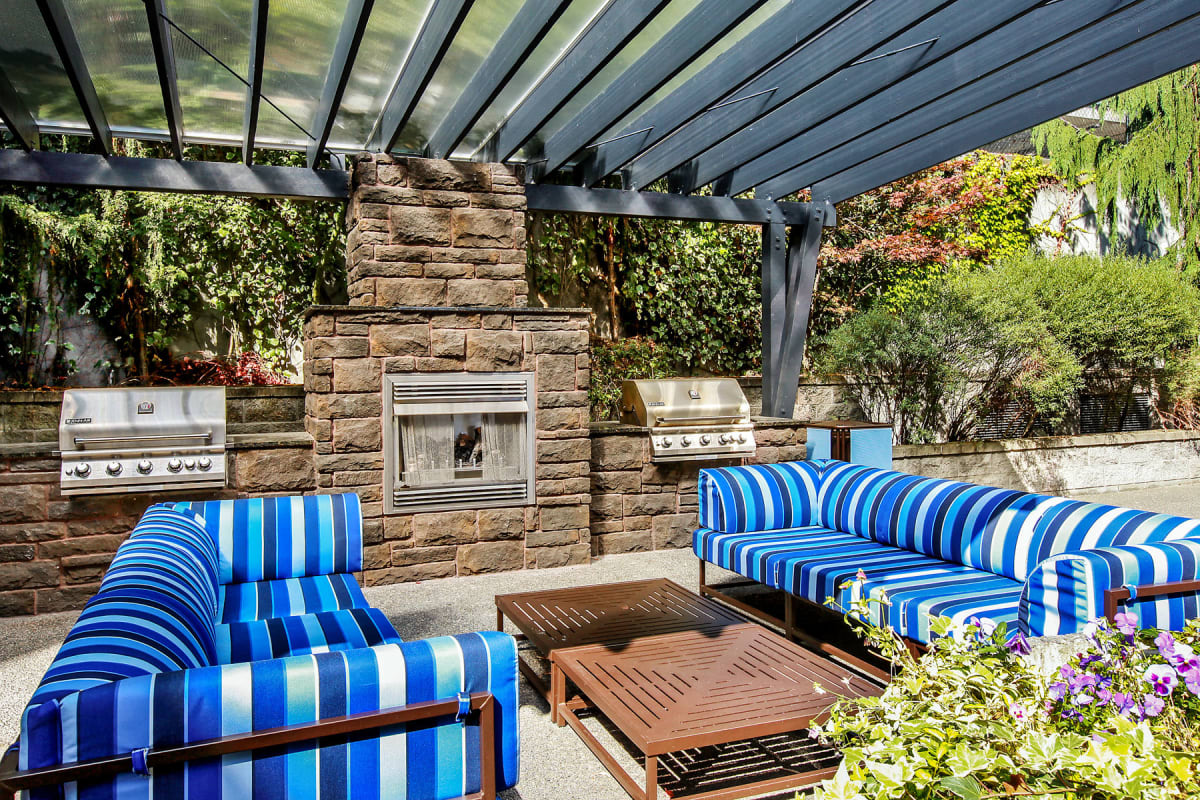 Well-furnished outdoor lounge area with a pergola overhead at Vantage Park Apartments in Seattle, Washington