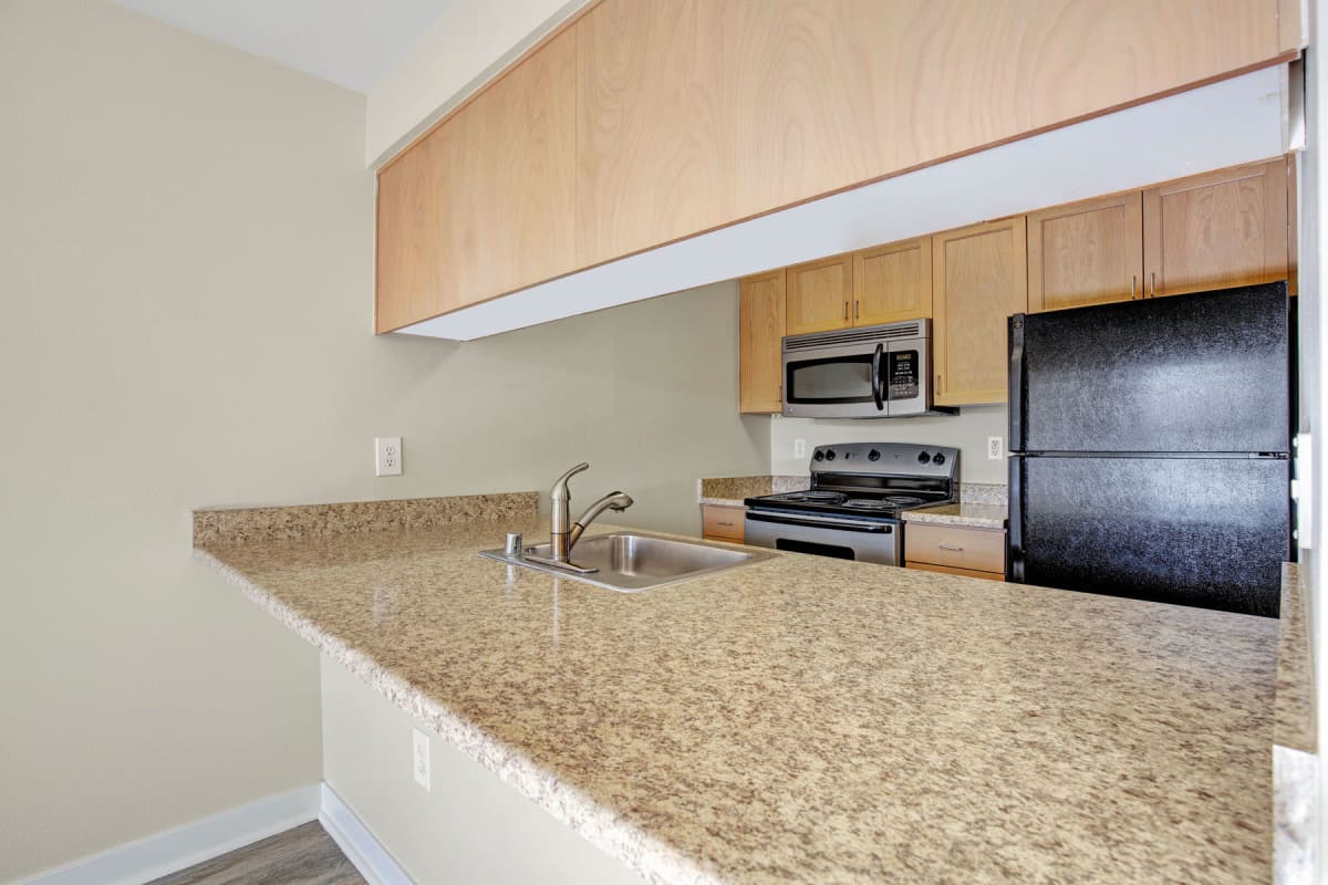 Apartment's kitchen with expansive granite countertops at Vantage Park Apartments in Seattle, Washington