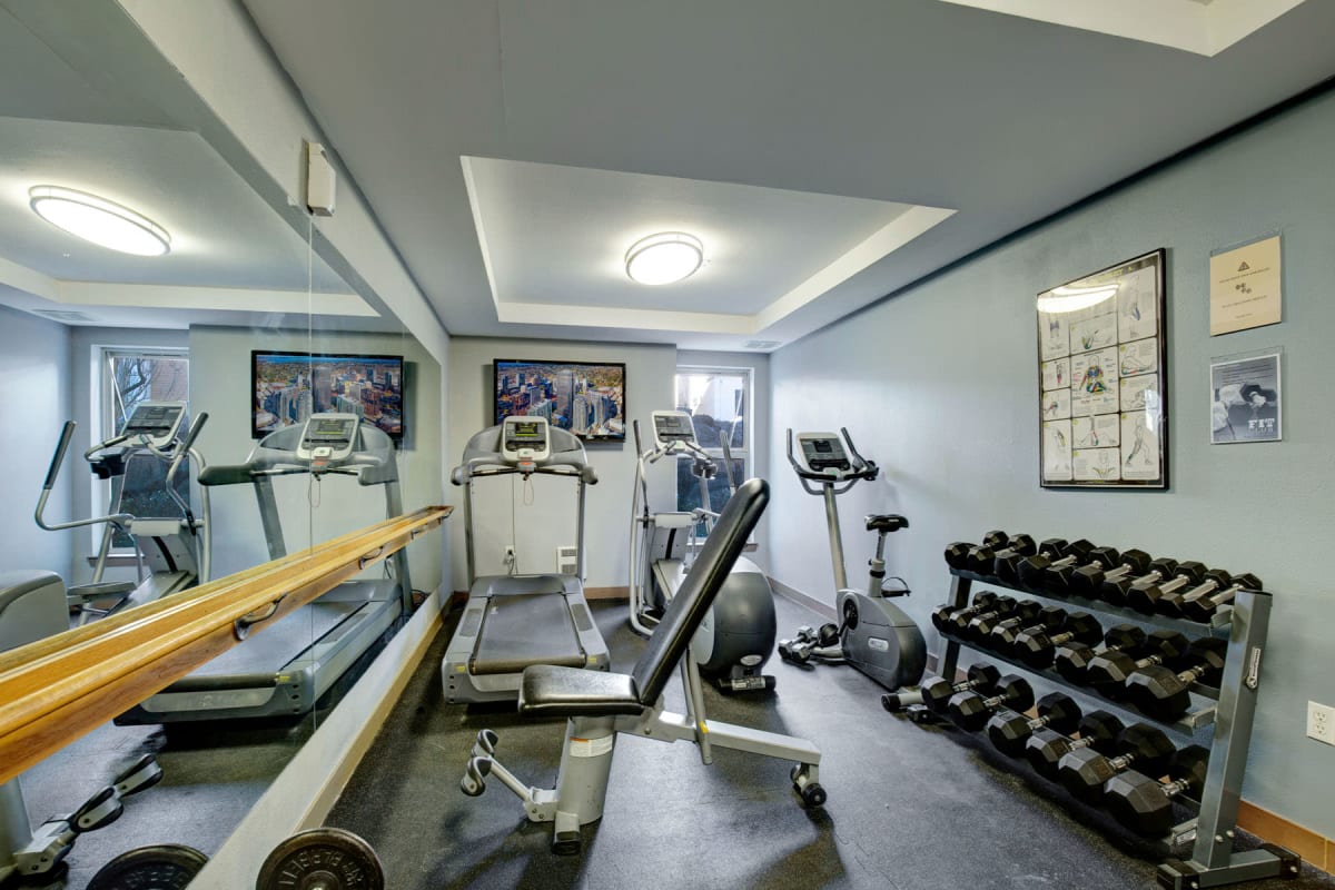 Free weights and exercise machines in the fitness center at Vantage Park Apartments in Seattle, Washington