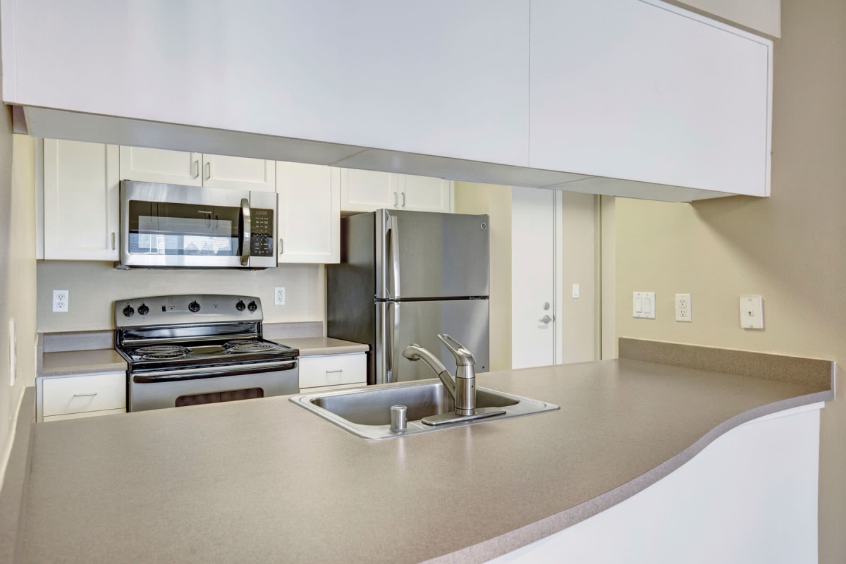 Stainless-steel appliances in a model apartment's kitchen at Vantage Park Apartments in Seattle, Washington