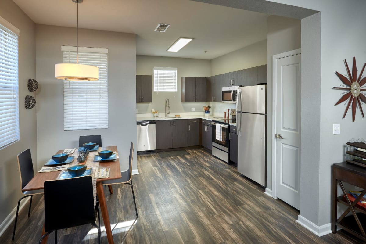 Gorgeous hardwood flooring and stainless steel appliances in the kitchen area at Marq Inverness in Englewood, Colorado