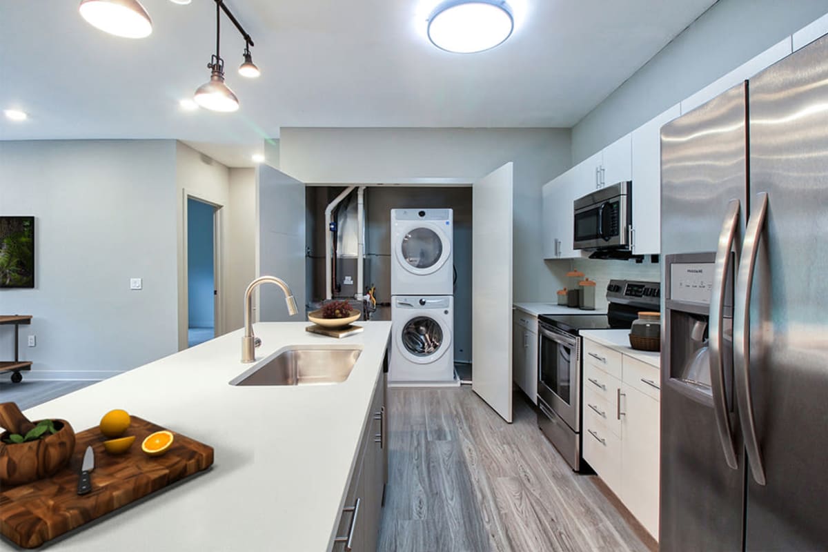 Gourmet kitchen with stainless steel appliances and quartz countertops and an in-home washer/dryer at 933 The U in Rochester, New York