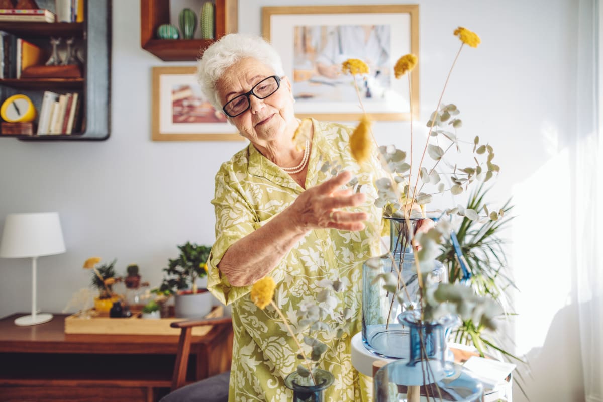 Resident tending to flower bouquet at Gentry Park Orlando in Orlando, Florida