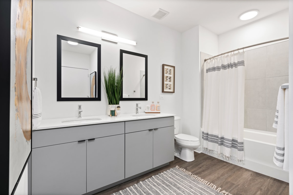 Spacious bathroom with two mirrors at The Residences at Sawmill Station in Morton Grove, Illinois