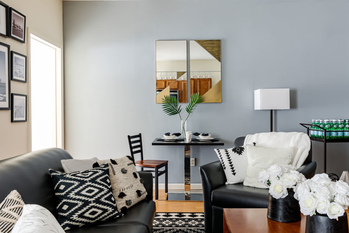 Student apartment's living space with an accent wall and modern decor at 20 Hawley in Binghamton, New York