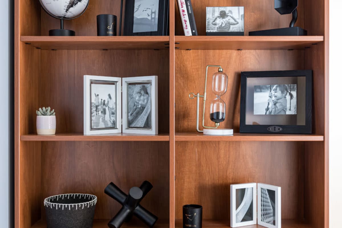 Built-in bookshelf adorned with photos and memorabilia in a model apartment at 20 Hawley in Binghamton, New York