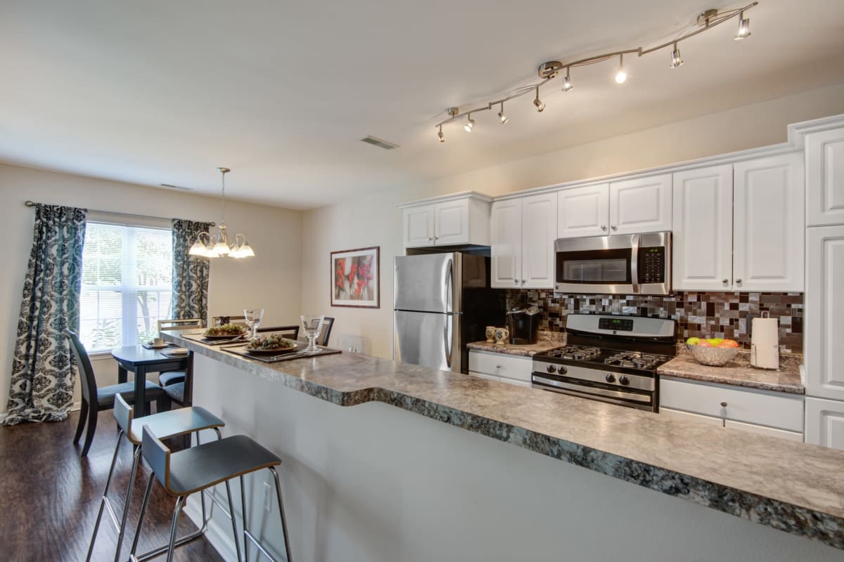 Modern kitchen with a breakfast bar at Oakmonte Apartments in Webster, New York