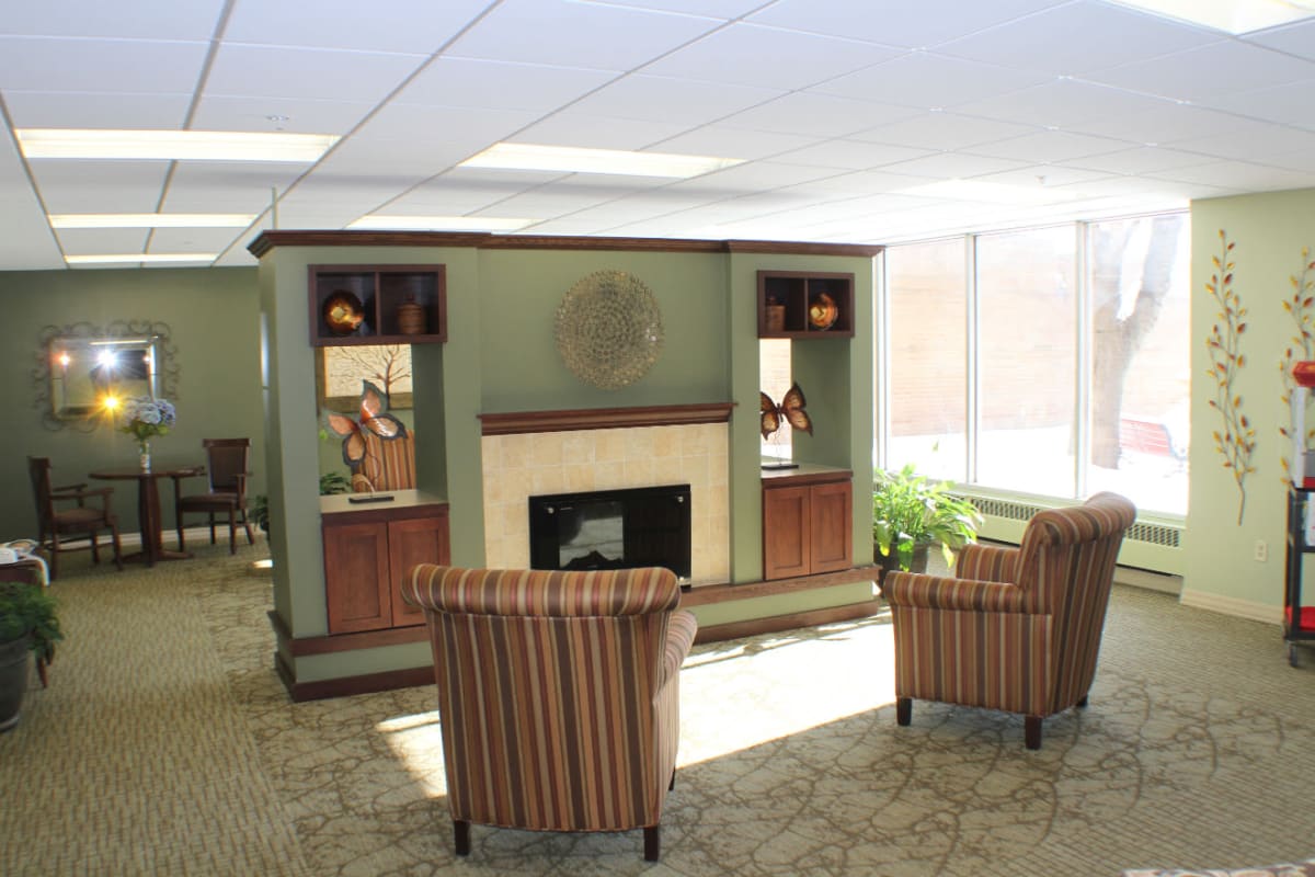 Living room area with a fireplace at Edgerton Care Center in Edgerton, Wisconsin