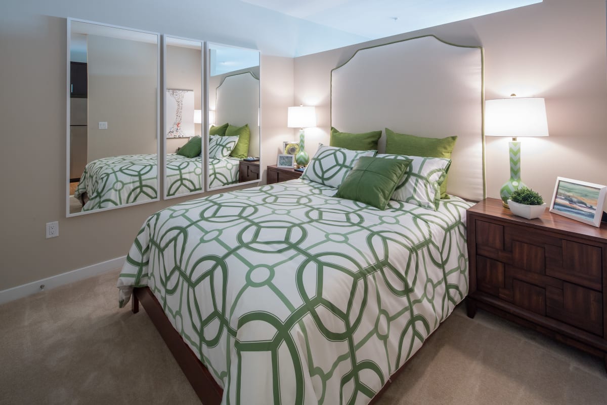 Cute bedroom with green and white decor on the bed at The Tala at Washington Hill in Baltimore, Maryland