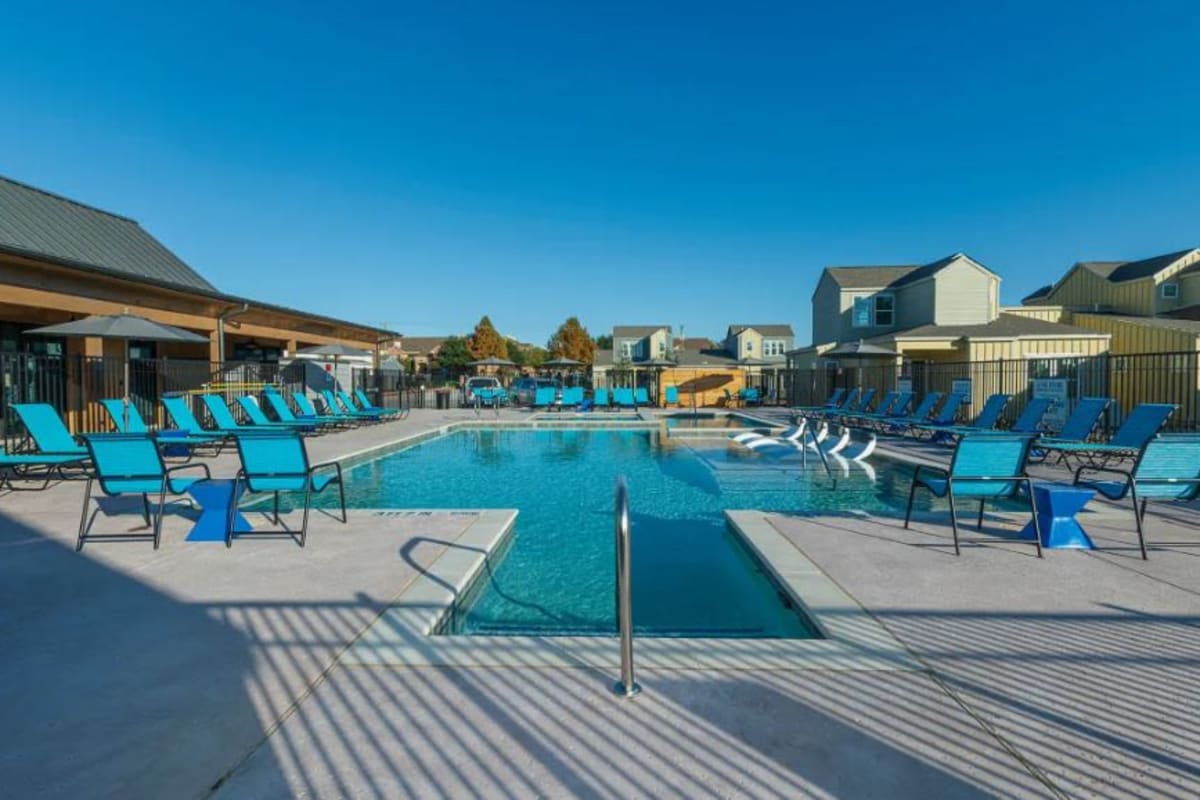 Beautiful swimming pool surrounded by lounge chairs at Elevate at Skyline in McKinney, Texas