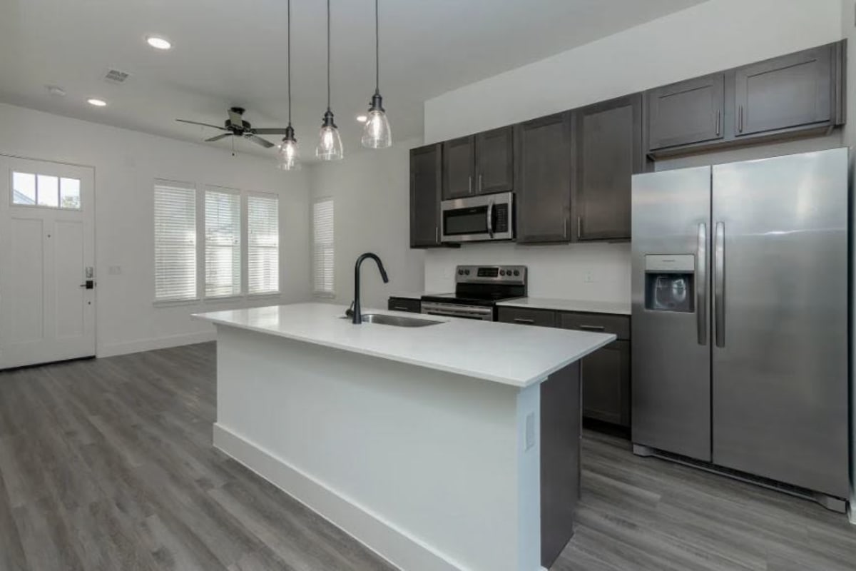 Contemporary kitchen with stainless steel appliances and an island at Elevate at Skyline in McKinney, Texas