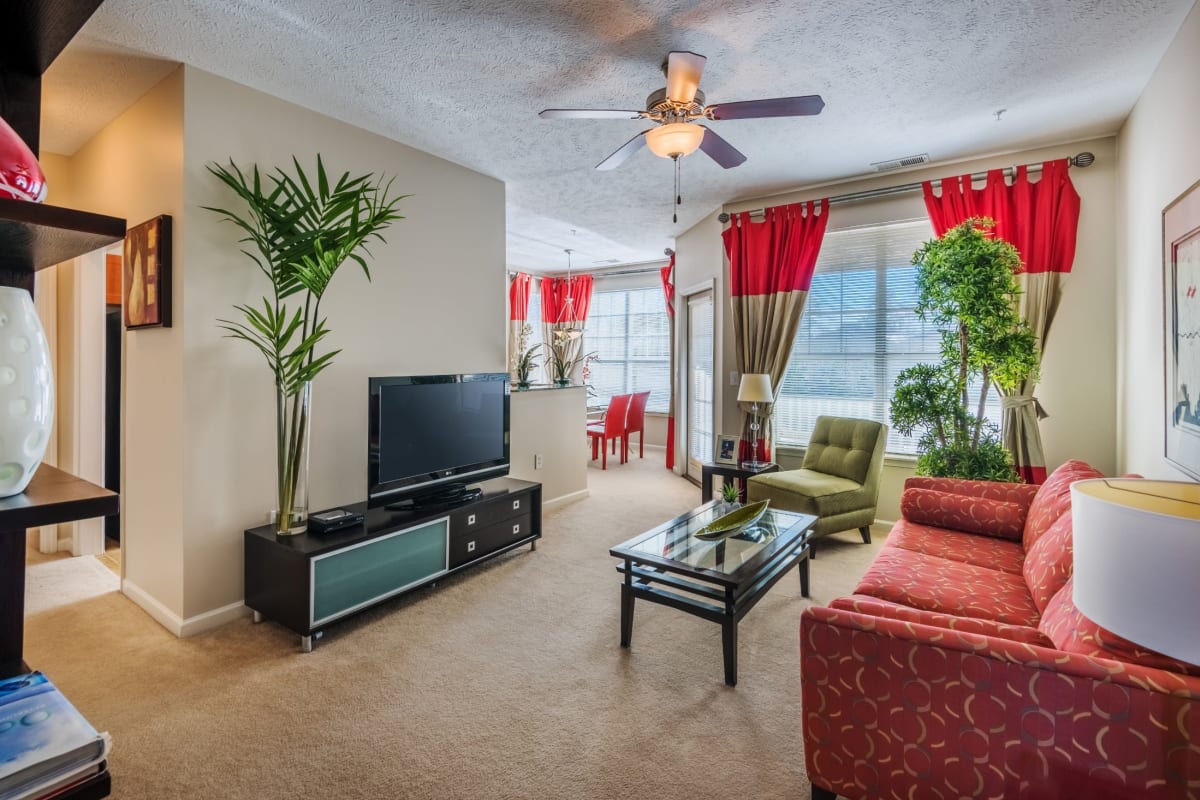 Spacious living room with wall-to-wall carpet and a ceiling fan at Westlake at Morganton in Fayetteville, North Carolina