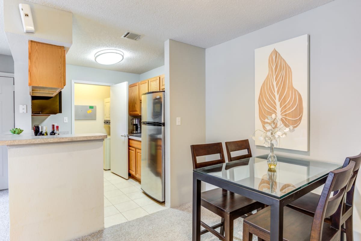 Dining area and kitchen of a model apartment at The Lakes of Schaumburg Apartment Homes in Schaumburg, Illinois