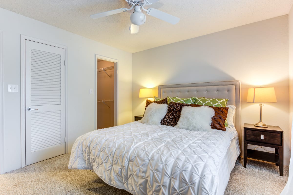 Spacious model bedroom with a ceiling fan and large closet at The Lakes of Schaumburg Apartment Homes in Schaumburg, Illinois