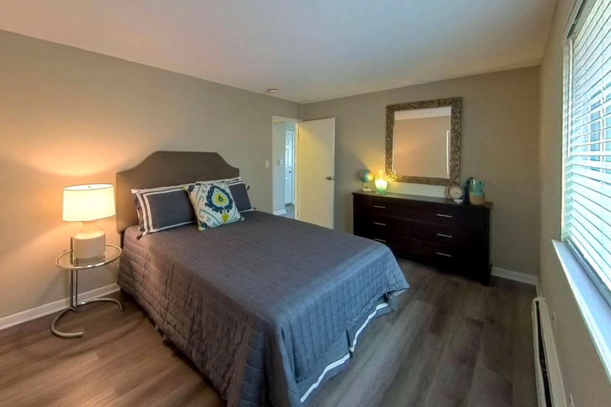 Model bedroom with gray accents at Courtyards on the Park in Des Plaines, Illinois