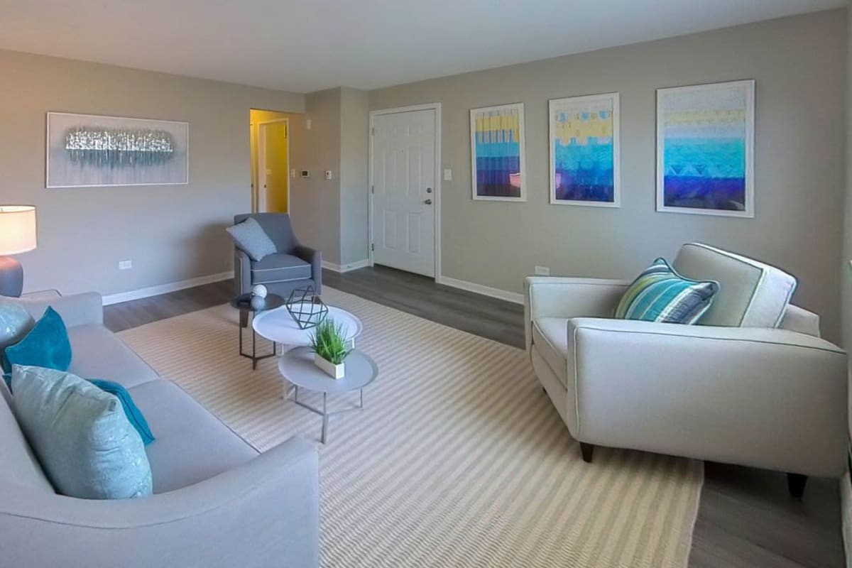 Model living space with blue wall art at Courtyards on the Park in Des Plaines, Illinois