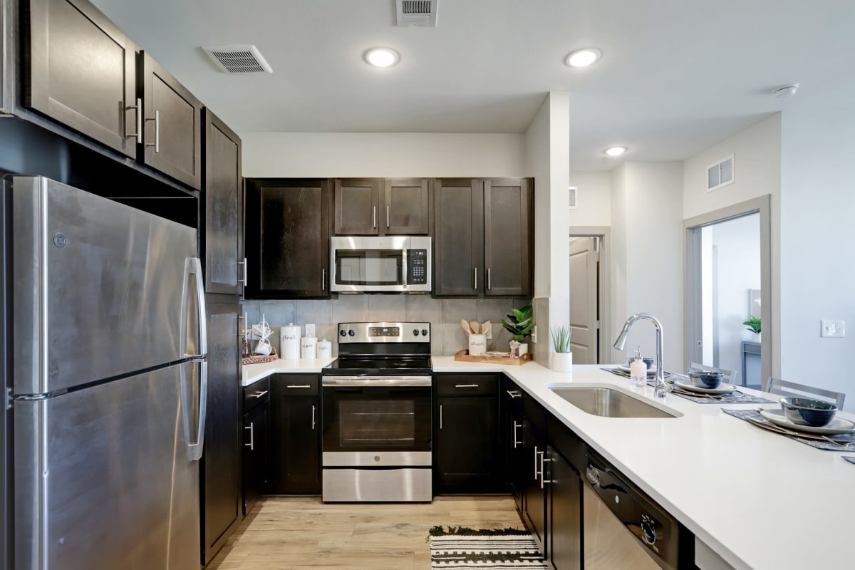 Fully equipped kitchen with stainless-steel appliances at Tower 5040 in Houston, Texas