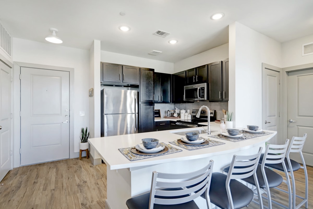 Gourmet kitchen with a breakfast bar at Tower 5040 in Houston, Texas