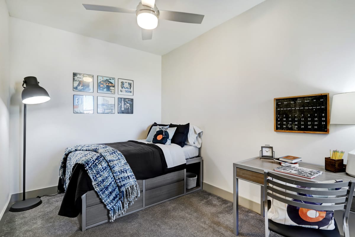 Student bedroom with a twin bed and desk at Tower 5040 in Houston, Texas