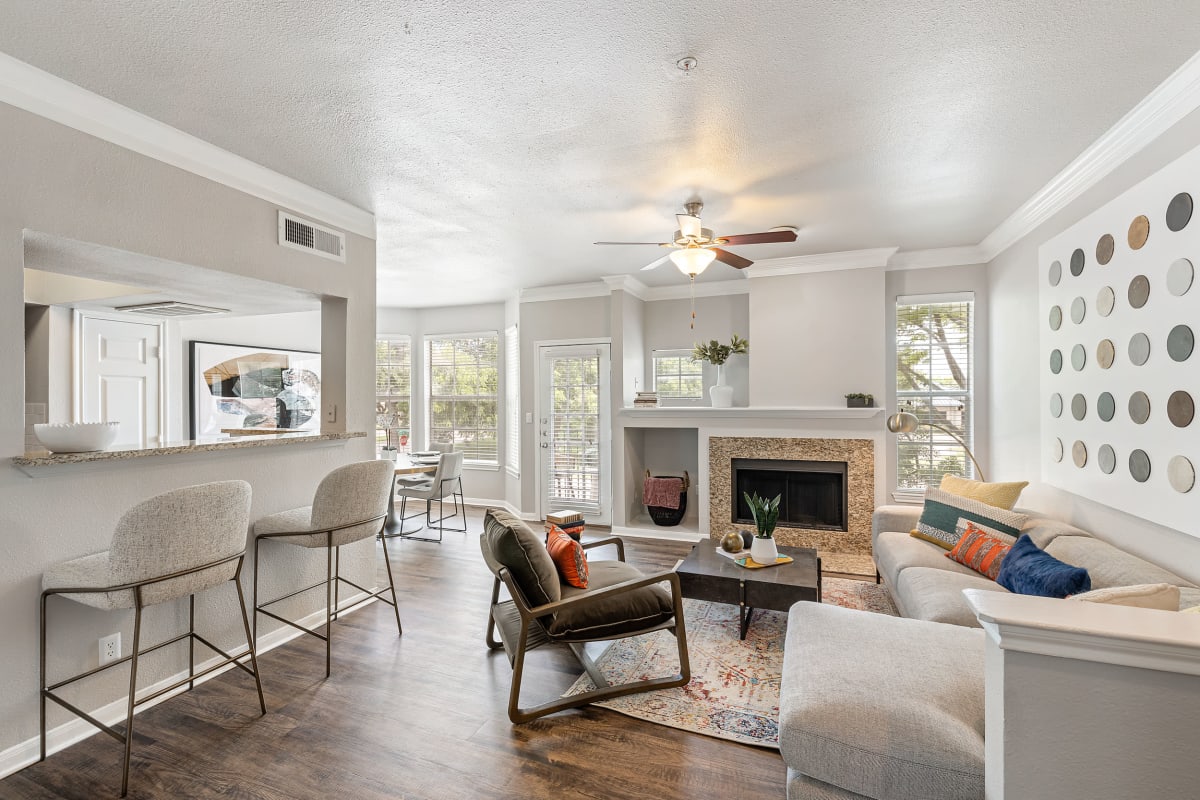 Spacious living room with fireplace and carpet at Marquis at Stonegate in Fort Worth, Texas