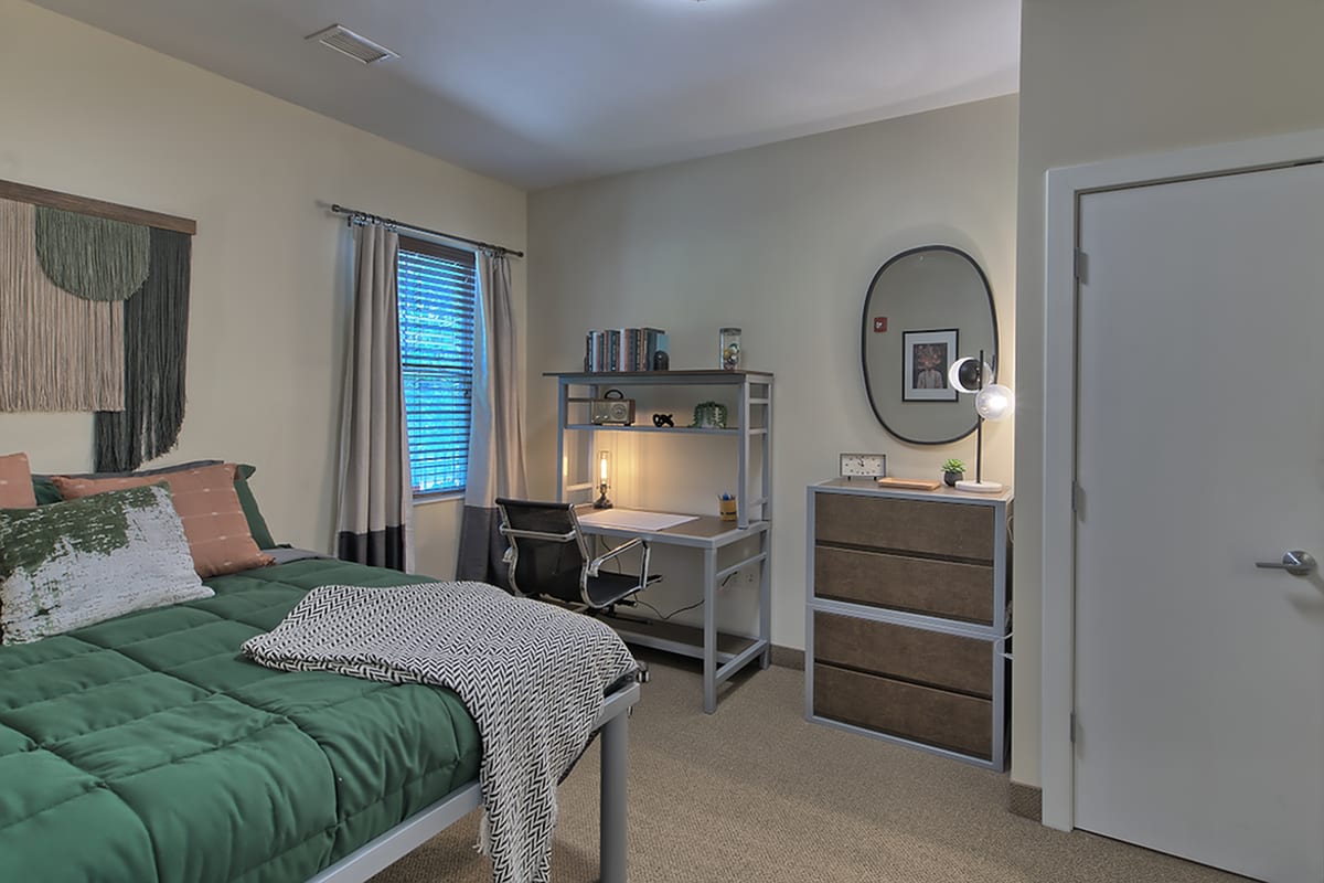 Bedroom with desk setup at Twin River Commons in Binghamton, New York