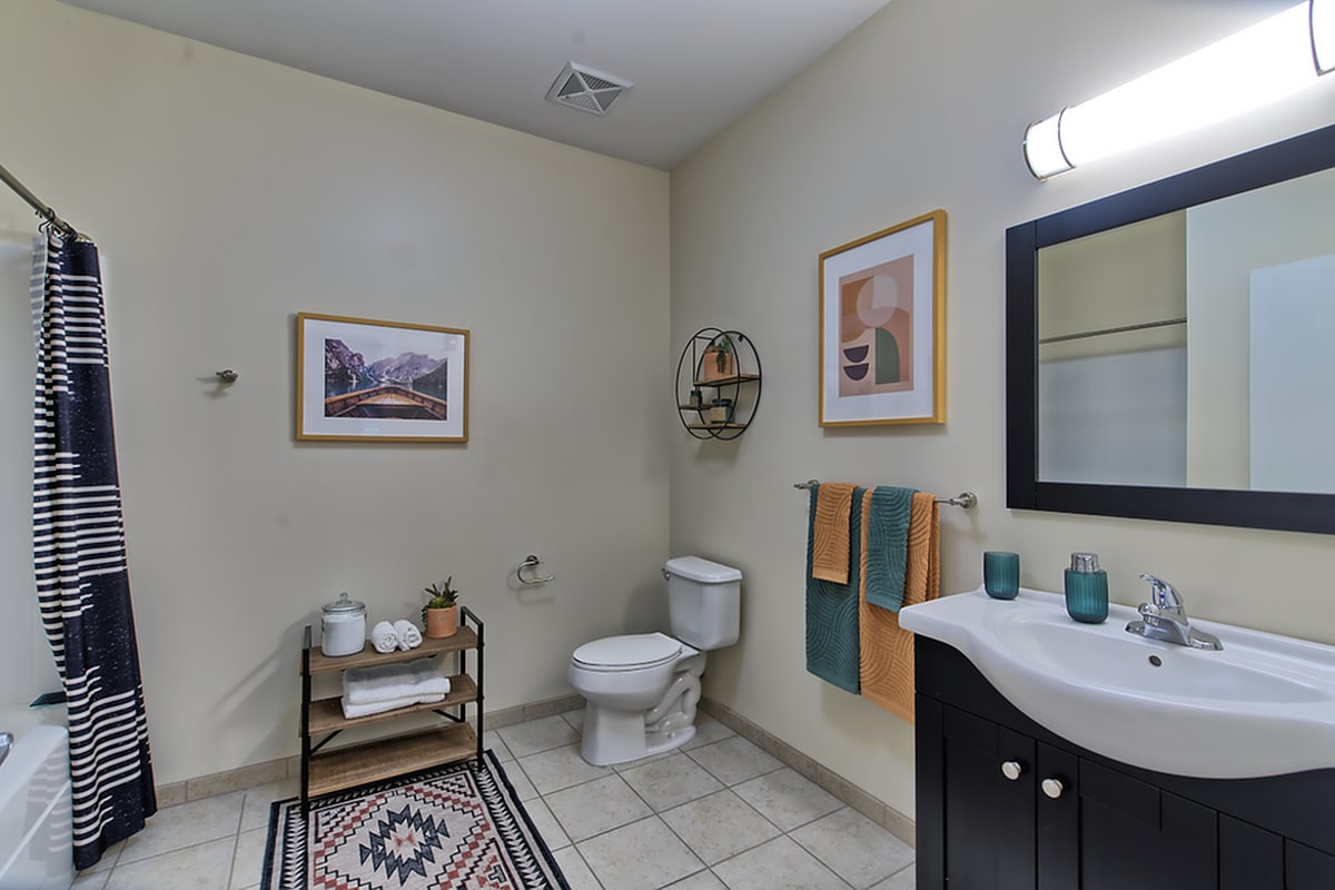 Model bathroom with tile flooring at Twin River Commons in Binghamton, New York