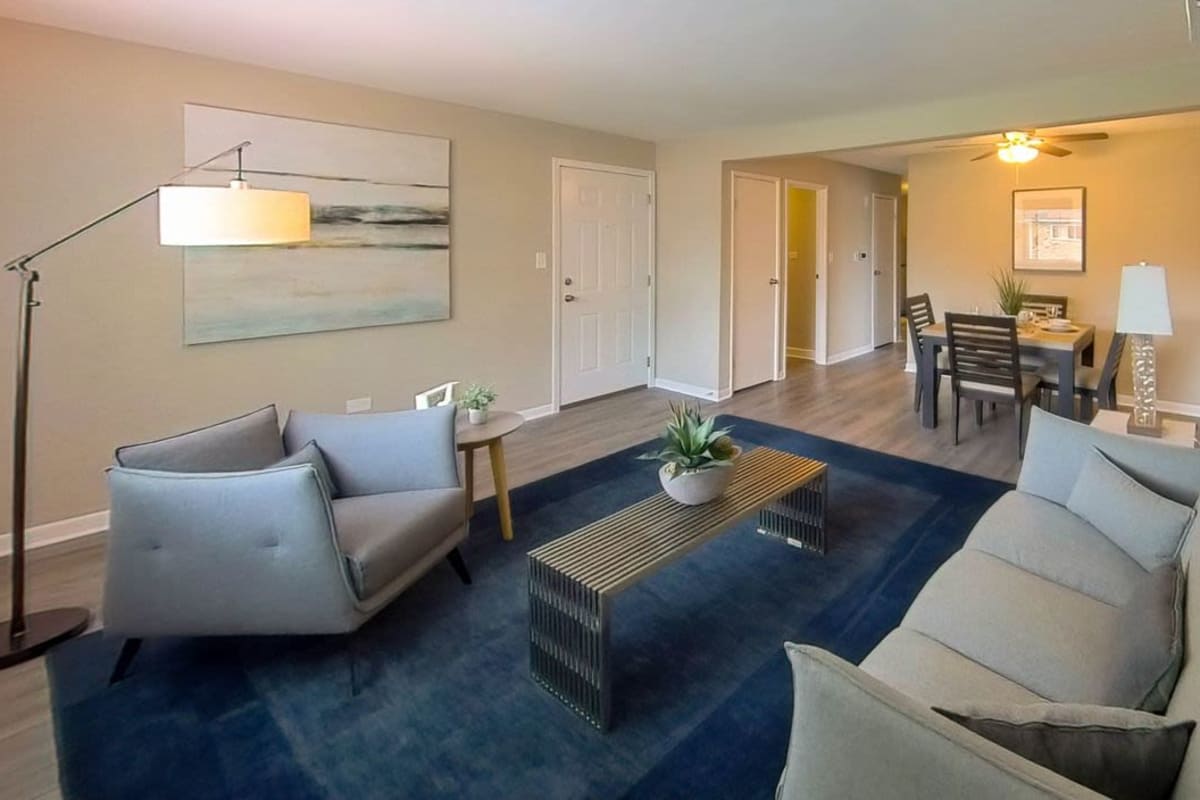 Model living space with blue rug at Courtyards on the Park in Des Plaines, Illinois