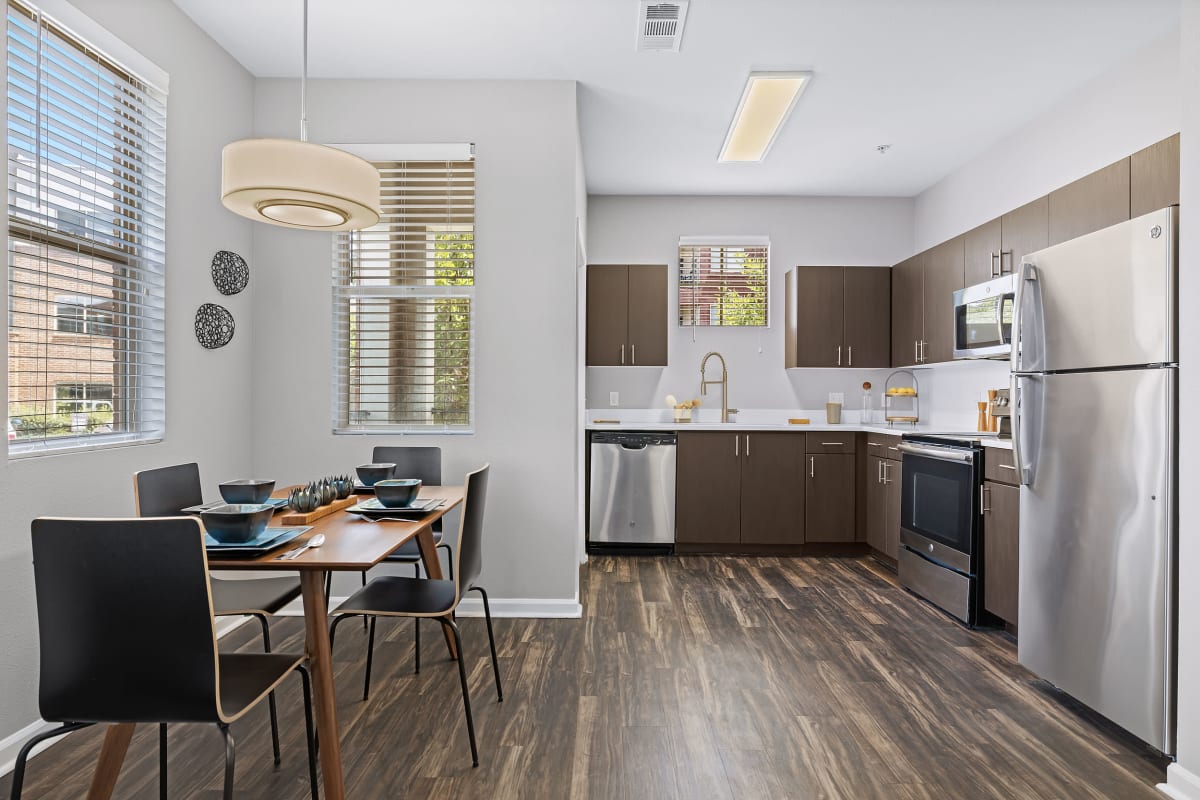 Gorgeous hardwood flooring and stainless steel appliances in the kitchen area at Marq Inverness in Englewood, Colorado