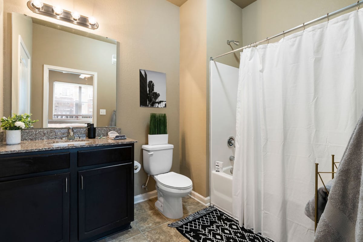 Clean bathroom with granite flooring at The Blake in Kennesaw, Georgia