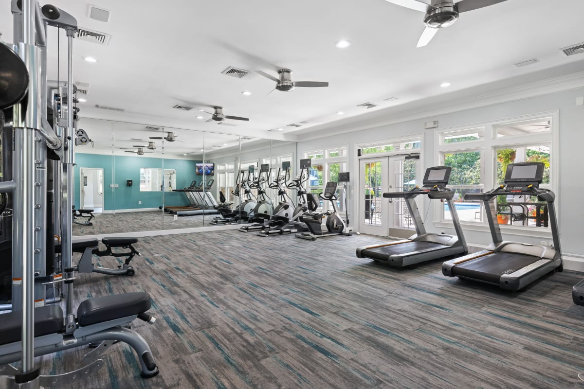 Treadmills and elliptical machines with view of outdoor pool at Marquis on Cary Parkway in Morrisville, North Carolina
