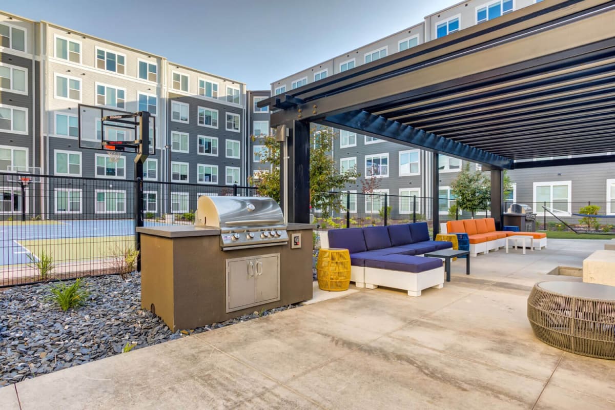 A covered, outdoor lounge and grilling station at The Banks Student Living in Coralville, Iowa