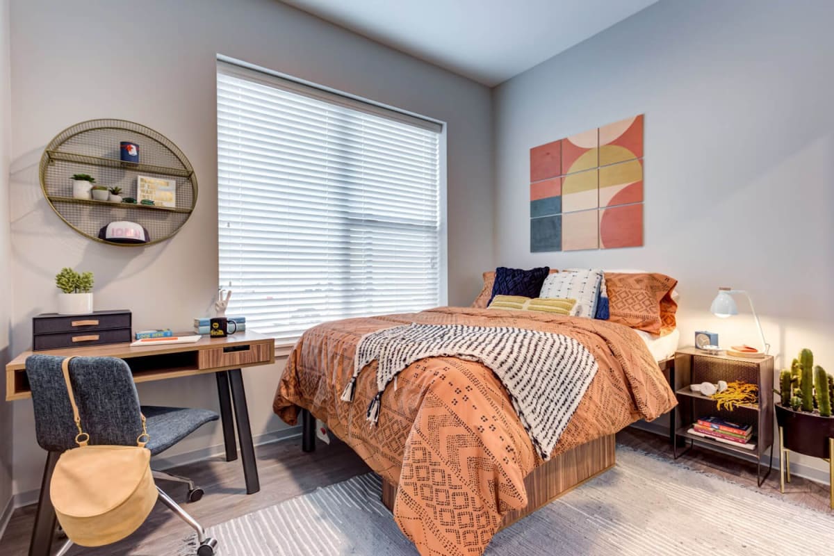 A furnished, welcoming apartment bedroom at The Banks in Coralville, Iowa