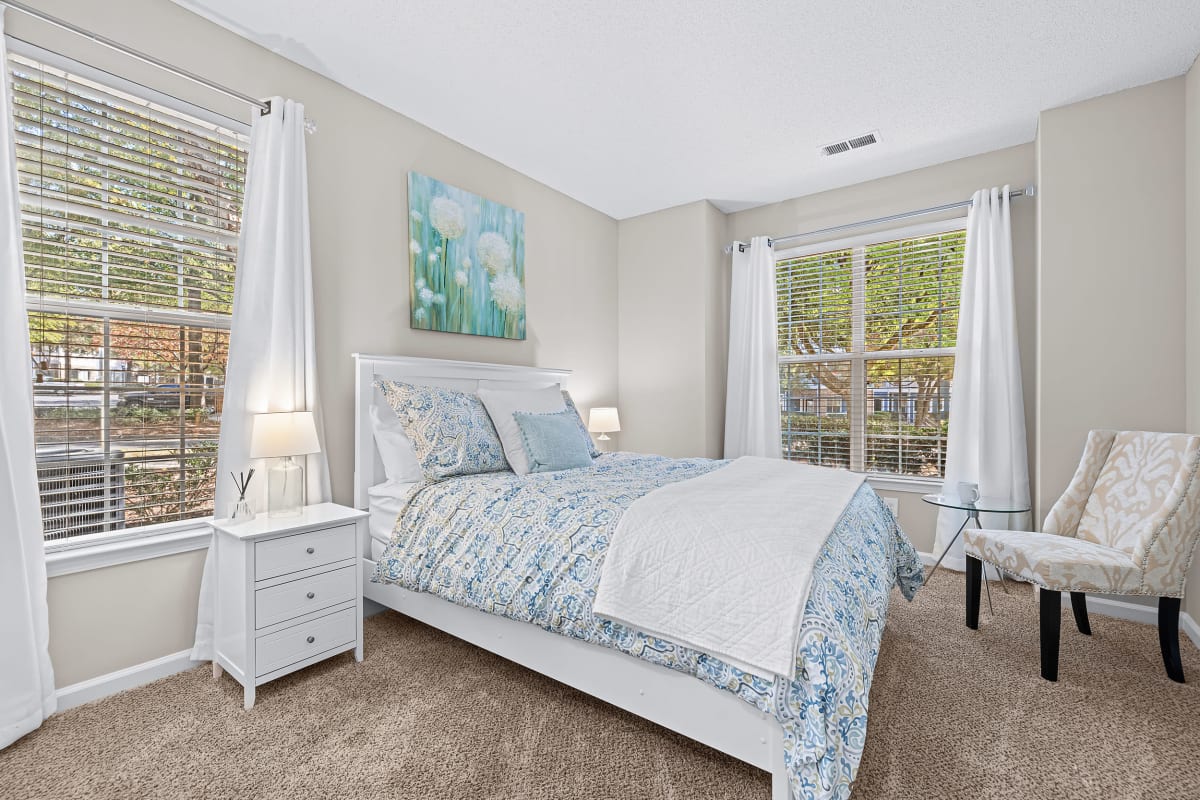 Bright bedroom with dual windows at Marquis on Edwards Mill in Raleigh, North Carolina
