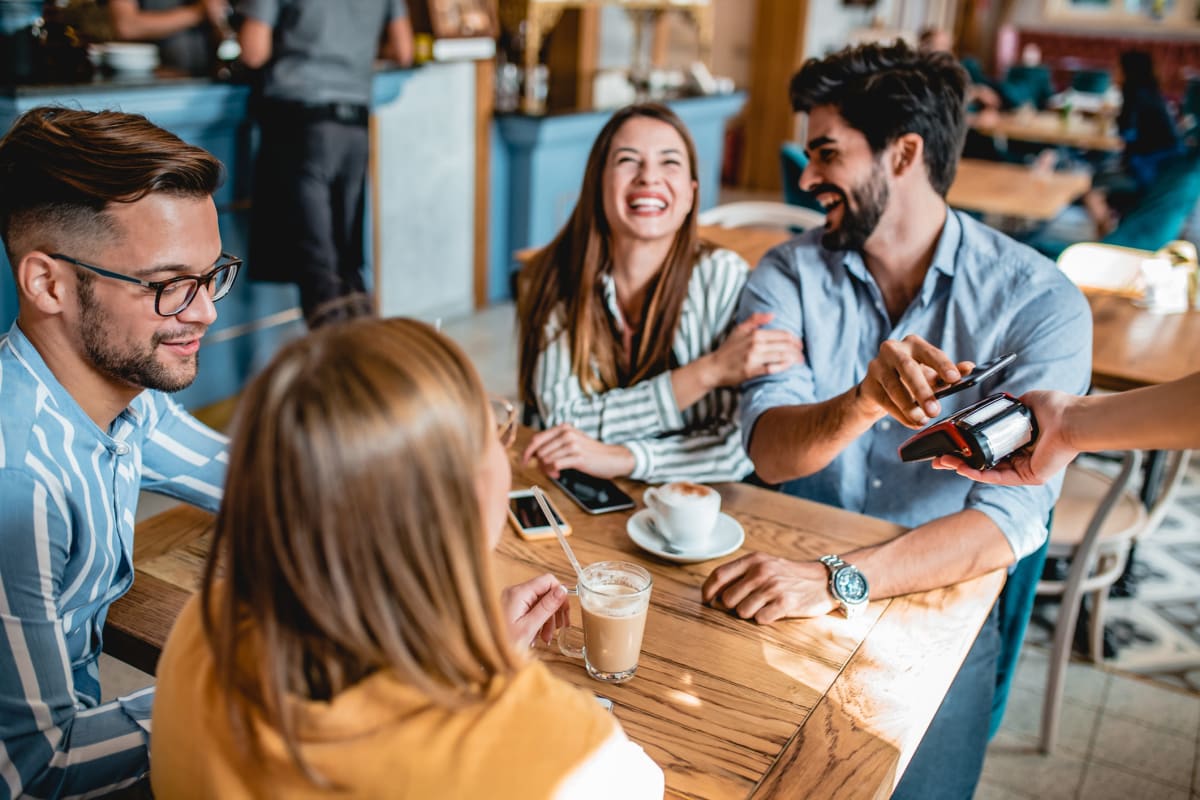 A group of friends eating at a restaurant near Integra Heights in Clermont, Florida