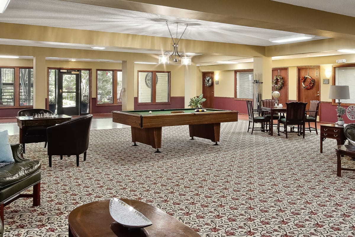 Resident recreation room with pool table at Trustwell Living of Raytown in Raytown, Missouri