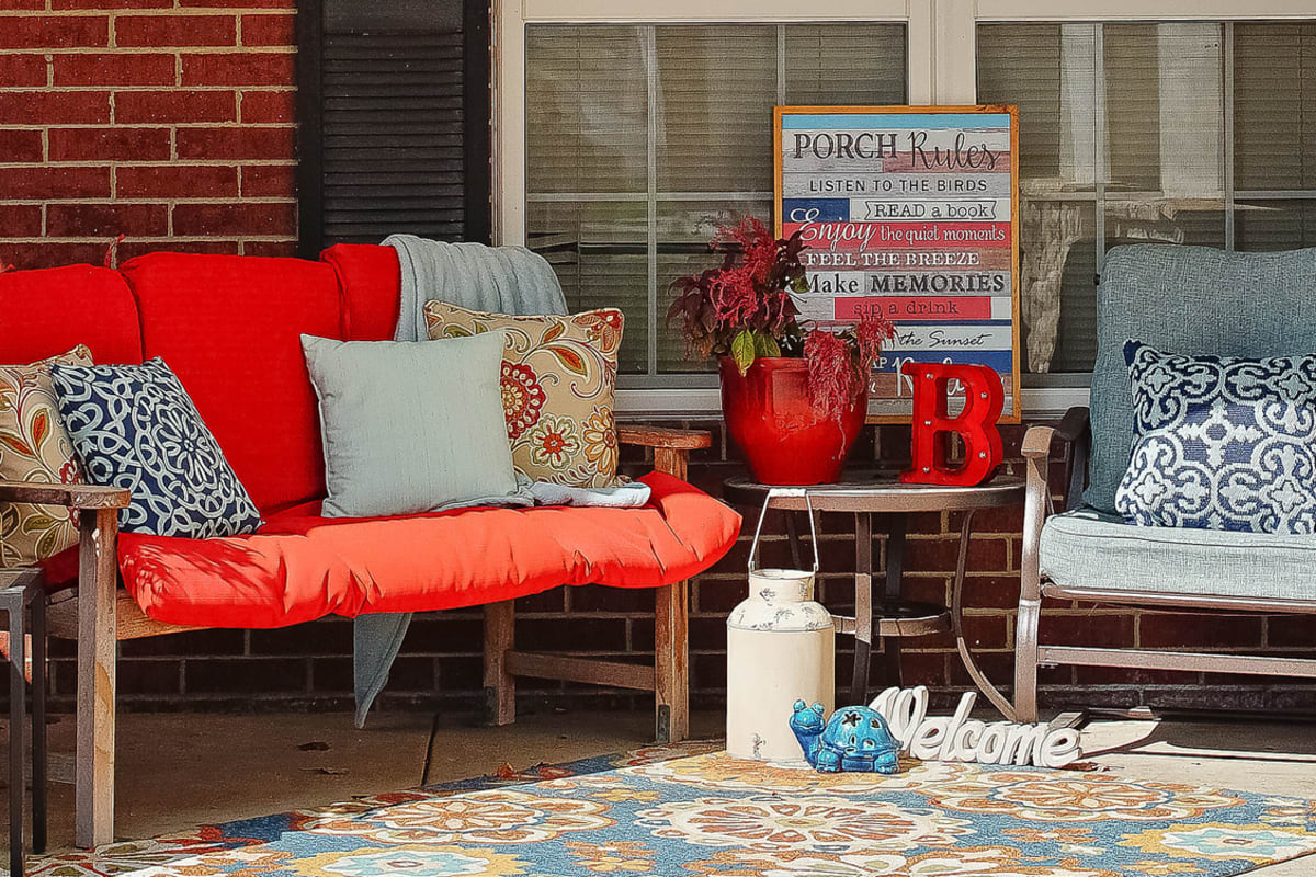 Apartment porch with outdoor furniture at Trustwell Living of Raytown in Raytown, Missouri