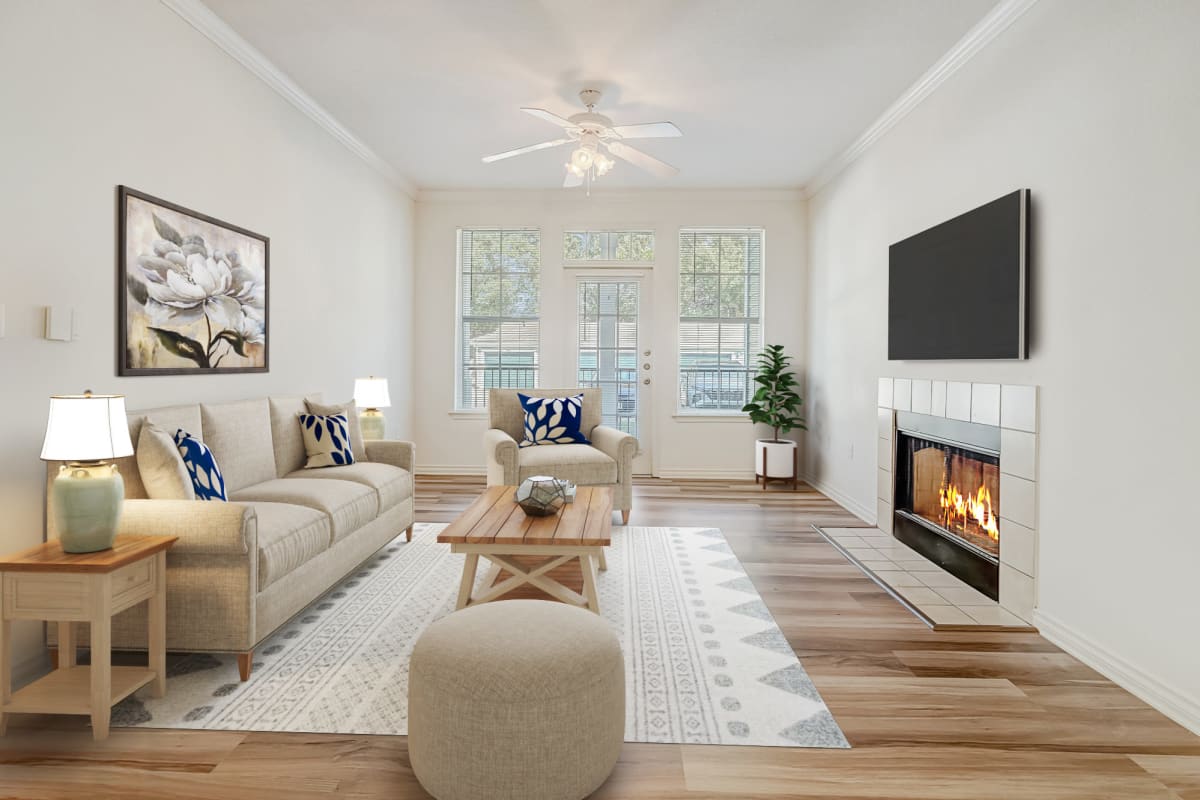Beautiful modern living room with fireplace at Audubon Lake Apartments in Lafayette, LA